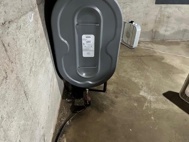 1039 Belfast Rd, Knox, ME 04986 - detailed view of unfinished concrete floors and oil tank