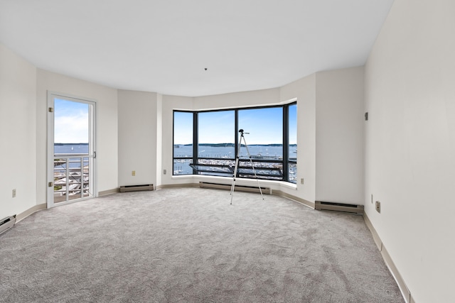 148 Breakwater Dr Unit 809, South Portland, ME 04106 - carpeted empty room featuring plenty of natural light, a baseboard heating unit, a water view, and a baseboard radiator