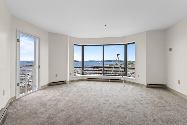 148 Breakwater Dr Unit 809, South Portland, ME 04106 - unfurnished room with a water view, carpet, and baseboard heating