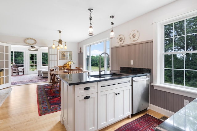 29 Folly Farm Rd, Lebanon, ME 04027 - kitchen with stainless steel dishwasher, a peninsula, hanging light fixtures, light wood-style flooring, and white cabinets