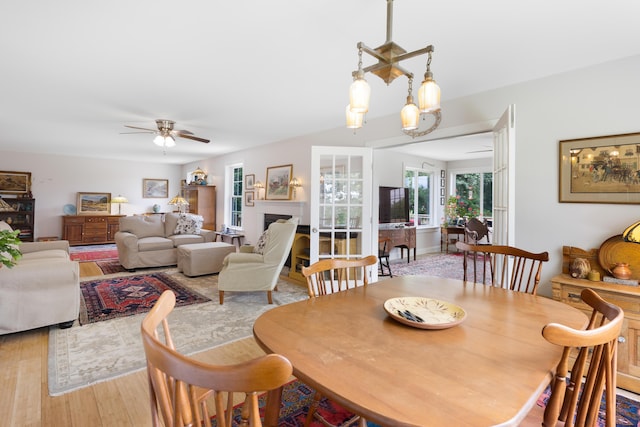 29 Folly Farm Rd, Lebanon, ME 04027 - dining space with wood finished floors, ceiling fan, and a fireplace