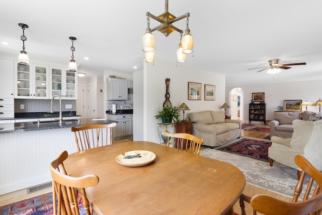 29 Folly Farm Rd, Lebanon, ME 04027 - dining area with wood finished floors, arched walkways, a ceiling fan, and recessed lighting
