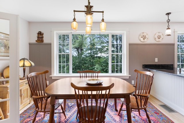 29 Folly Farm Rd, Lebanon, ME 04027 - dining space with plenty of natural light, wood finished floors, and a wainscoted wall