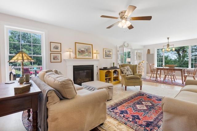 29 Folly Farm Rd, Lebanon, ME 04027 - living area featuring a glass covered fireplace, ceiling fan, and a chandelier