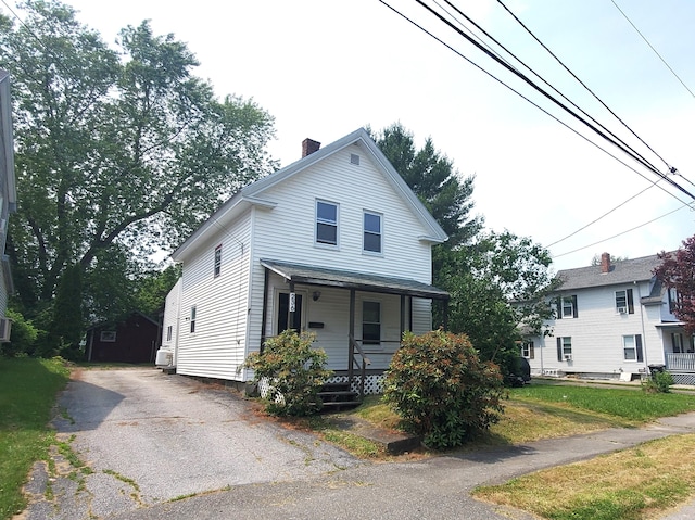 236 Birch St, Bangor, ME 04401 - view of front of house with a porch, a chimney, and asphalt driveway