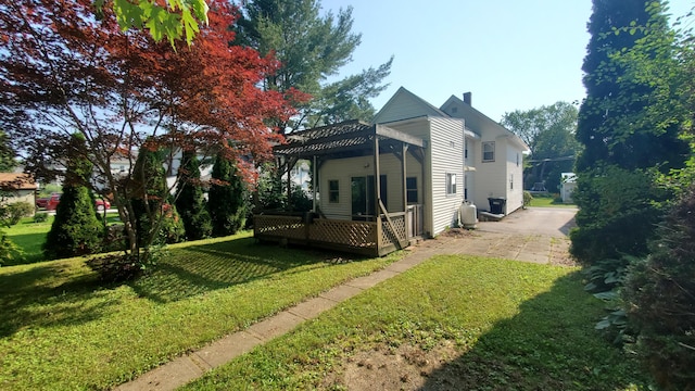 236 Birch St, Bangor, ME 04401 - view of side of property with a yard, a wooden deck, driveway, and a chimney