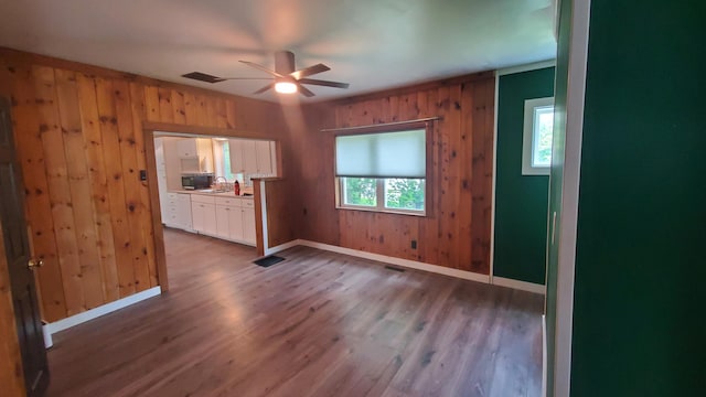 236 Birch St, Bangor, ME 04401 - empty room featuring a ceiling fan, wood finished floors, and wood walls