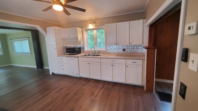 236 Birch St, Bangor, ME 04401 - kitchen with dishwasher, ceiling fan, dark wood finished floors, white cabinetry, and tasteful backsplash