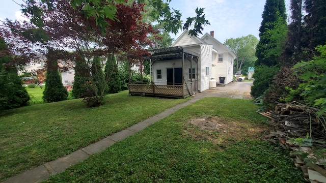 236 Birch St, Bangor, ME 04401 - back of property featuring a pergola, a wooden deck, a chimney, driveway, and a yard