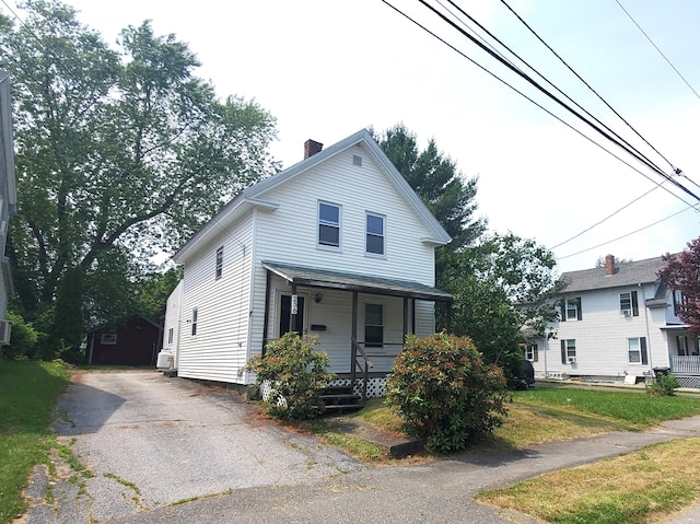 236 Birch St, Bangor, ME 04401 - view of front of house featuring covered porch, a chimney, driveway, and an outdoor structure