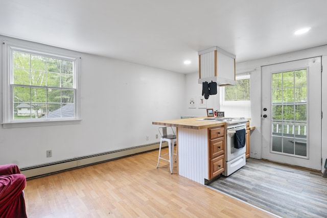 14 Lakeshore Dr, Belgrade, ME 04918 - kitchen featuring white stove, a baseboard heating unit, wood counters, plenty of natural light, and recessed lighting