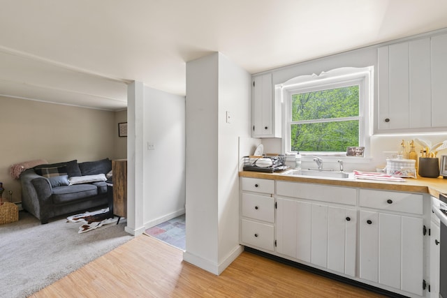 14 Lakeshore Dr, Belgrade, ME 04918 - kitchen featuring light wood-type flooring, white cabinetry, light countertops, and open floor plan
