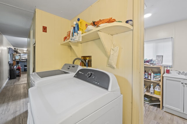 14 Lakeshore Dr, Belgrade, ME 04918 - laundry area featuring washing machine and clothes dryer, light wood-type flooring, and a decorative wall