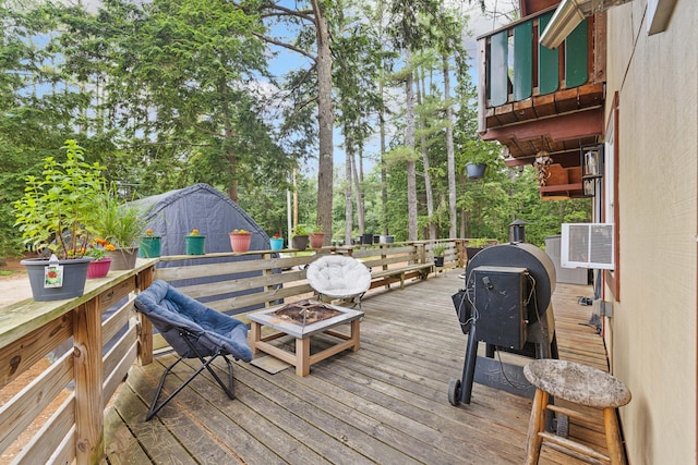 11 Ridgewood Dr, Lebanon, ME 04027 - wooden terrace with an outdoor fire pit and view of scattered trees