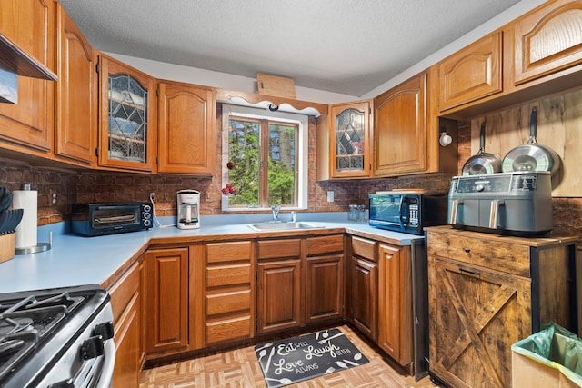 11 Ridgewood Dr, Lebanon, ME 04027 - kitchen with black microwave, decorative backsplash, a textured ceiling, and brown cabinets