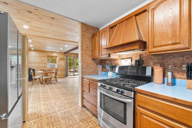 11 Ridgewood Dr, Lebanon, ME 04027 - kitchen featuring stainless steel appliances, custom range hood, light countertops, recessed lighting, and brown cabinets
