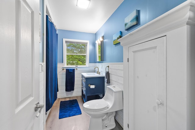 11 Ridgewood Dr, Lebanon, ME 04027 - full bathroom featuring a wainscoted wall, vanity, wood finished floors, and curtained shower