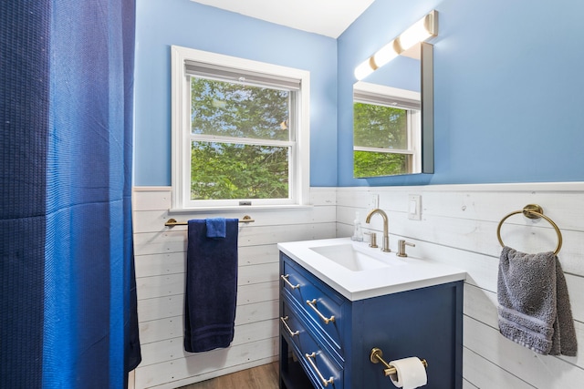 11 Ridgewood Dr, Lebanon, ME 04027 - full bathroom with vanity, wainscoting, and wood finished floors