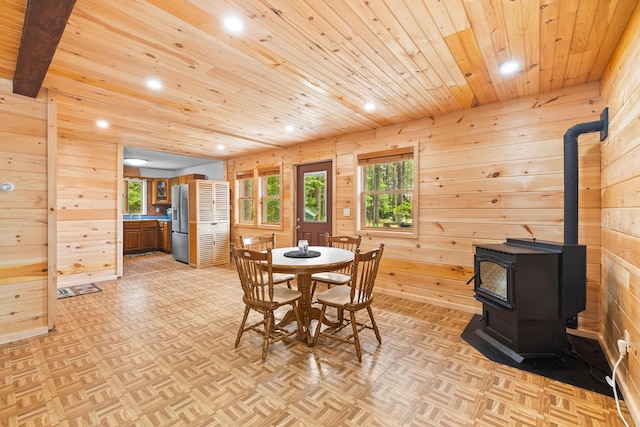 11 Ridgewood Dr, Lebanon, ME 04027 - dining area with wooden ceiling, recessed lighting, wood walls, and a wood stove