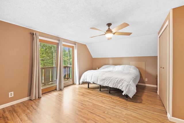 11 Ridgewood Dr, Lebanon, ME 04027 - bedroom featuring access to outside, a textured ceiling, light wood-style floors, vaulted ceiling, and a ceiling fan
