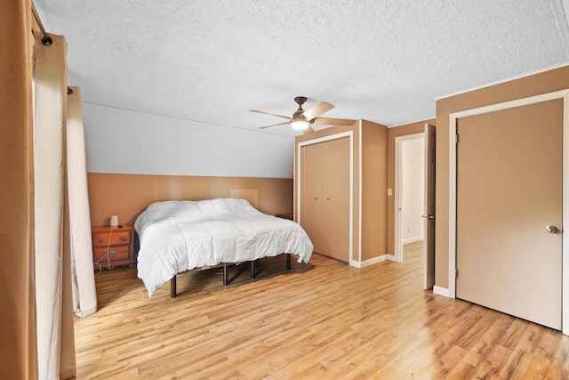 11 Ridgewood Dr, Lebanon, ME 04027 - bedroom with a textured ceiling, light wood-type flooring, a closet, ceiling fan, and vaulted ceiling