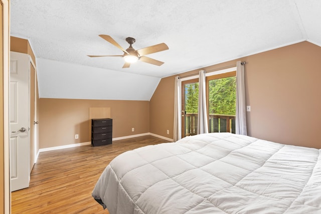 11 Ridgewood Dr, Lebanon, ME 04027 - bedroom with vaulted ceiling, access to exterior, wood finished floors, a textured ceiling, and ceiling fan