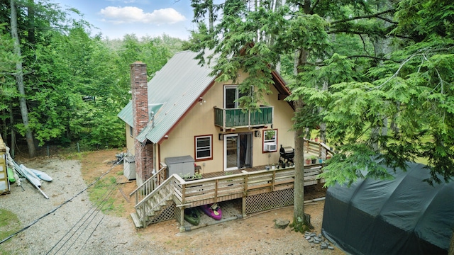 11 Ridgewood Dr, Lebanon, ME 04027 - back of property featuring a balcony, a chimney, a metal roof, stairs, and a wooden deck