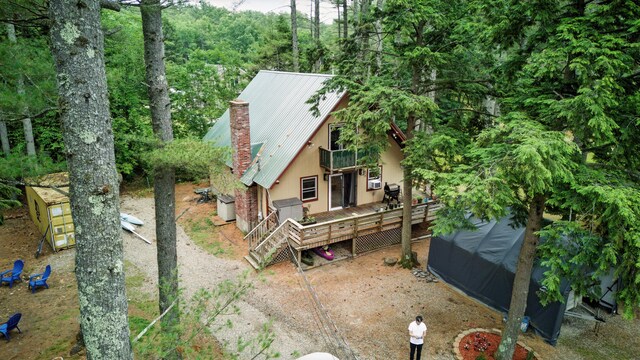 11 Ridgewood Dr, Lebanon, ME 04027 - view of front of house featuring a balcony, a metal roof, a wooden deck, and a chimney