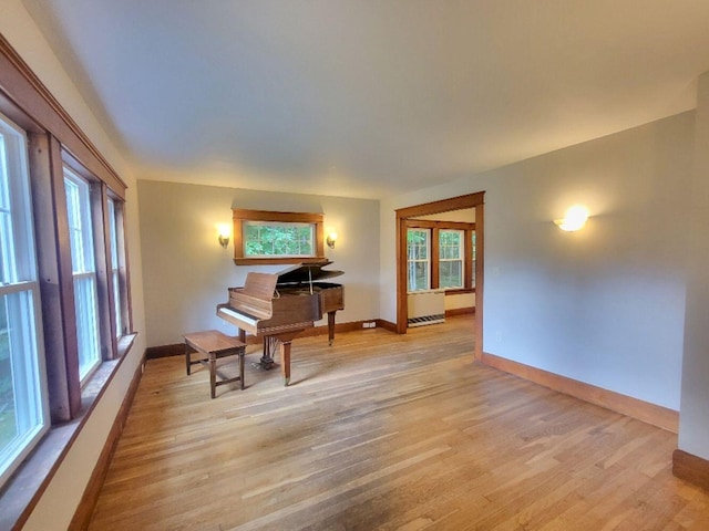 12 Allen St, Wilton, ME 04294 - sitting room with plenty of natural light, light wood-type flooring, and radiator heating unit