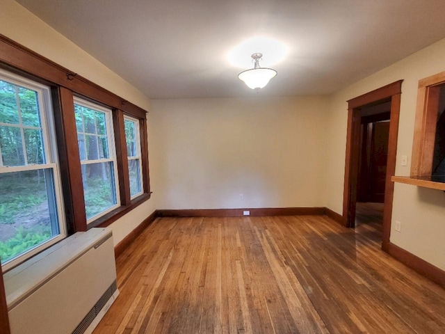 12 Allen St, Wilton, ME 04294 - unfurnished room featuring radiator, light wood-style flooring, and healthy amount of natural light
