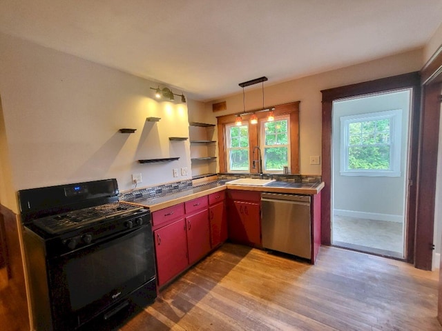12 Allen St, Wilton, ME 04294 - kitchen featuring gas stove, stainless steel dishwasher, wood finished floors, red cabinets, and pendant lighting