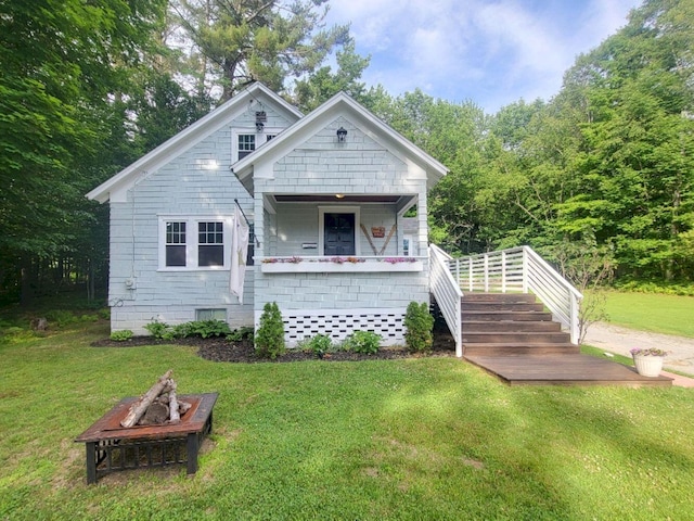 12 Allen St, Wilton, ME 04294 - view of front of property with a front yard and a fire pit