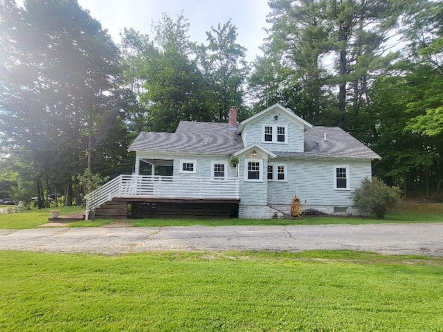 12 Allen St, Wilton, ME 04294 - view of front of house with a front yard, a chimney, a deck, and stairway