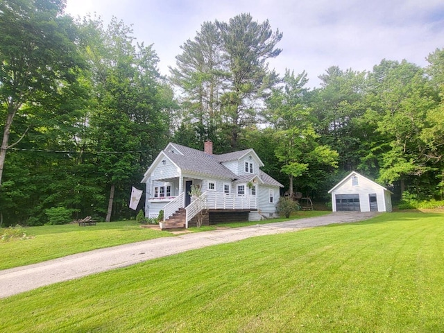 12 Allen St, Wilton, ME 04294 - view of front facade featuring an outbuilding, a garage, driveway, a chimney, and a front yard