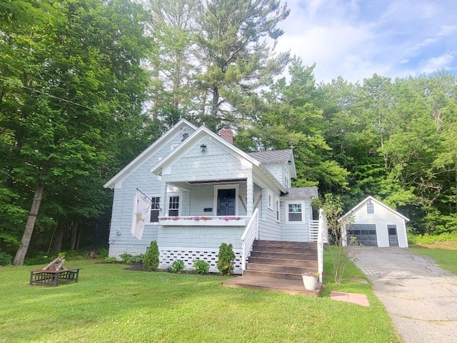 12 Allen St, Wilton, ME 04294 - bungalow-style home with an outbuilding, a garage, a front lawn, a chimney, and an outdoor fire pit