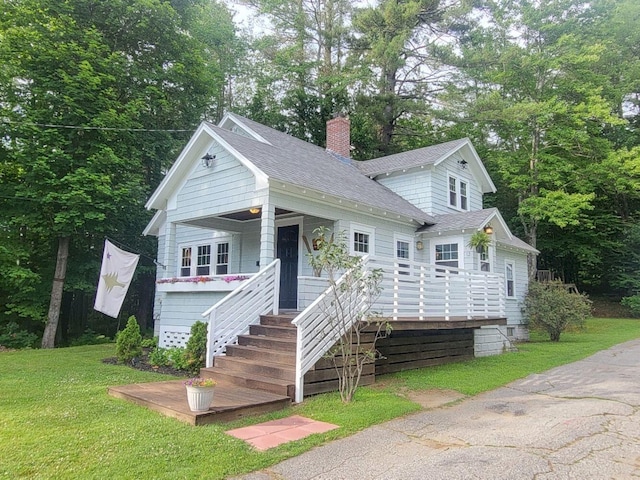 12 Allen St, Wilton, ME 04294 - view of front of home featuring roof with shingles, stairway, a chimney, and a front lawn