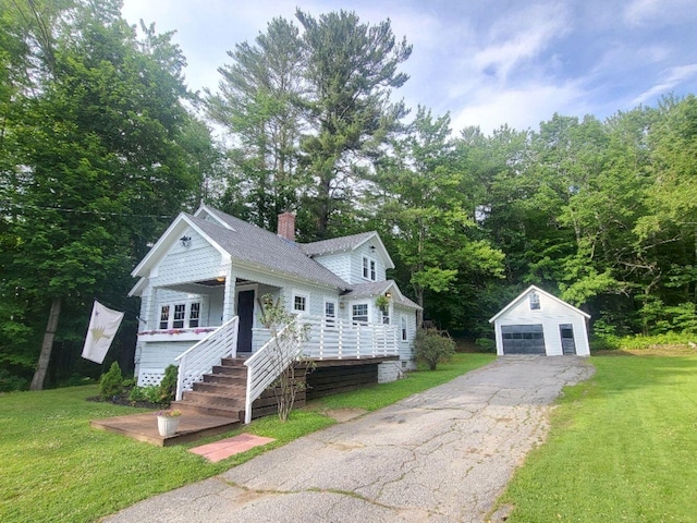 12 Allen St, Wilton, ME 04294 - view of front of house with an outbuilding, a garage, a chimney, and a front yard