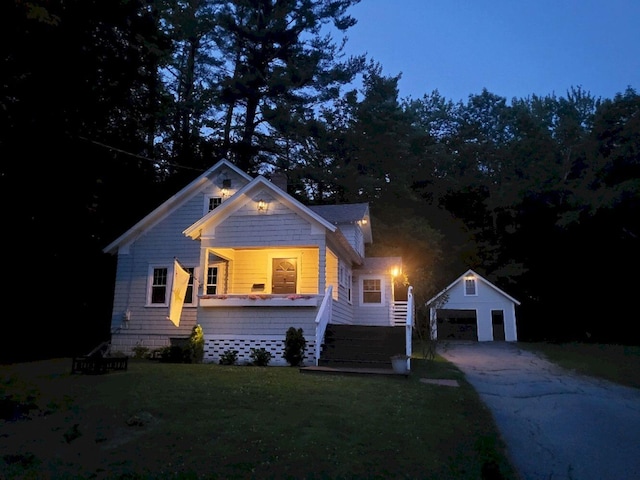 12 Allen St, Wilton, ME 04294 - view of front of property featuring a detached garage, an outdoor structure, a front lawn, and stairs