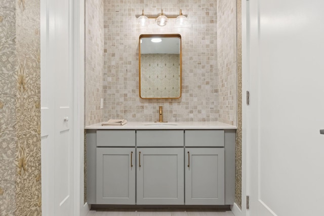 218 Washington Ave Unit 107, Portland, ME 04101 - bathroom with vanity and decorative backsplash