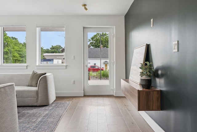218 Washington Ave Unit 107, Portland, ME 04101 - doorway featuring hardwood / wood-style floors and baseboards