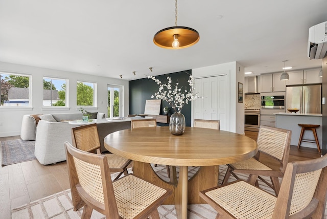 218 Washington Ave Unit 107, Portland, ME 04101 - dining space with light wood-style floors and baseboards