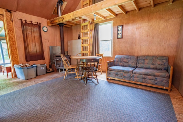 LOT4 Brimstone Rd, Lagrange, ME 04453 - dining room featuring a wood stove, beamed ceiling, and wood walls