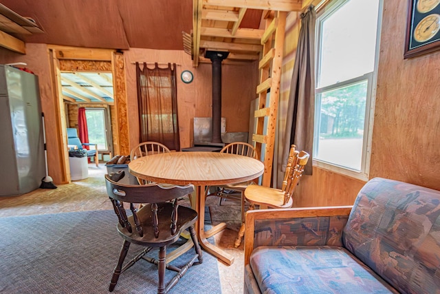 LOT4 Brimstone Rd, Lagrange, ME 04453 - dining area featuring a wood stove, plenty of natural light, and wood walls