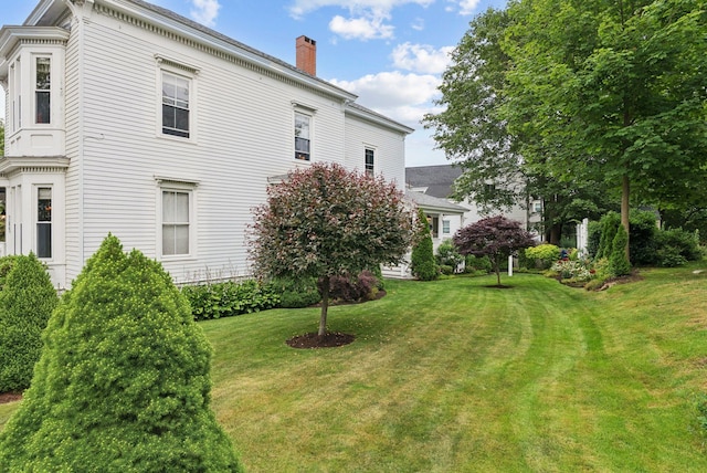709 High St, Bath, ME 04530 - view of home's exterior featuring a chimney and a yard