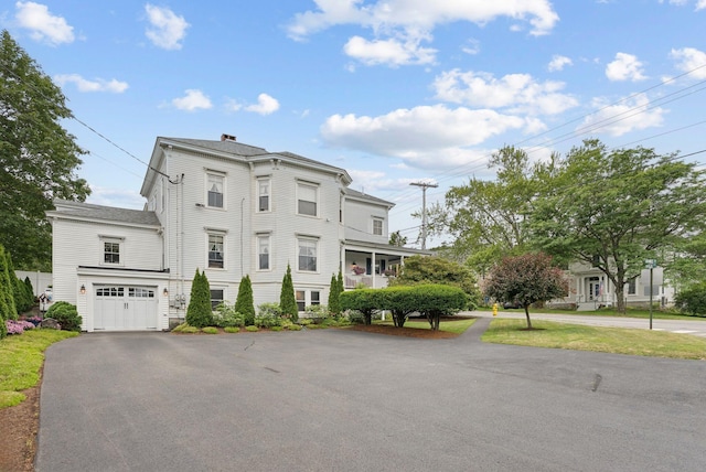 709 High St, Bath, ME 04530 - italianate house featuring asphalt driveway, a chimney, and an attached garage