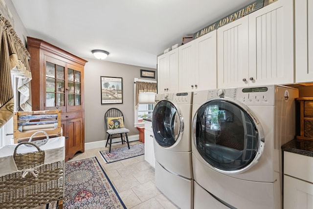 709 High St, Bath, ME 04530 - laundry room featuring washing machine and dryer, cabinet space, and light tile patterned floors