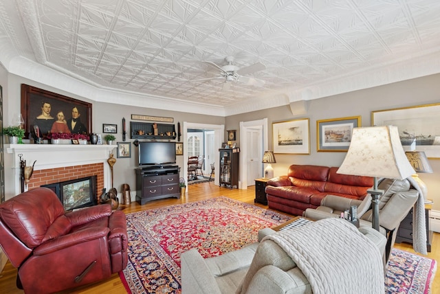 709 High St, Bath, ME 04530 - living area with an ornate ceiling, wood finished floors, ceiling fan, a fireplace, and crown molding