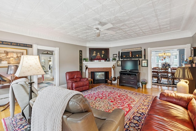 709 High St, Bath, ME 04530 - living room featuring an ornate ceiling, ceiling fan, wood finished floors, a fireplace, and a chandelier