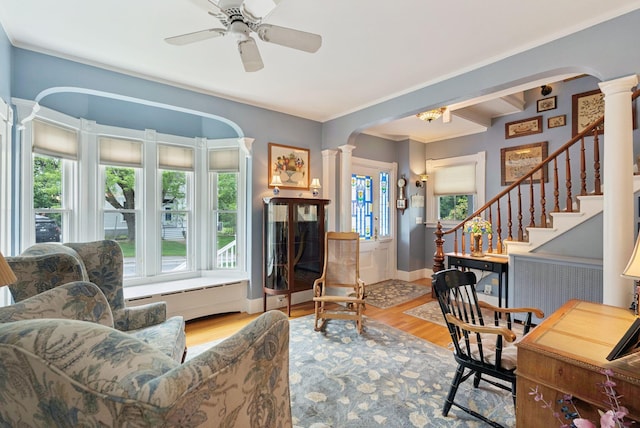709 High St, Bath, ME 04530 - living room with decorative columns, arched walkways, wood finished floors, and crown molding