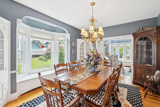 709 High St, Bath, ME 04530 - dining space with a chandelier, healthy amount of natural light, and light wood-style flooring